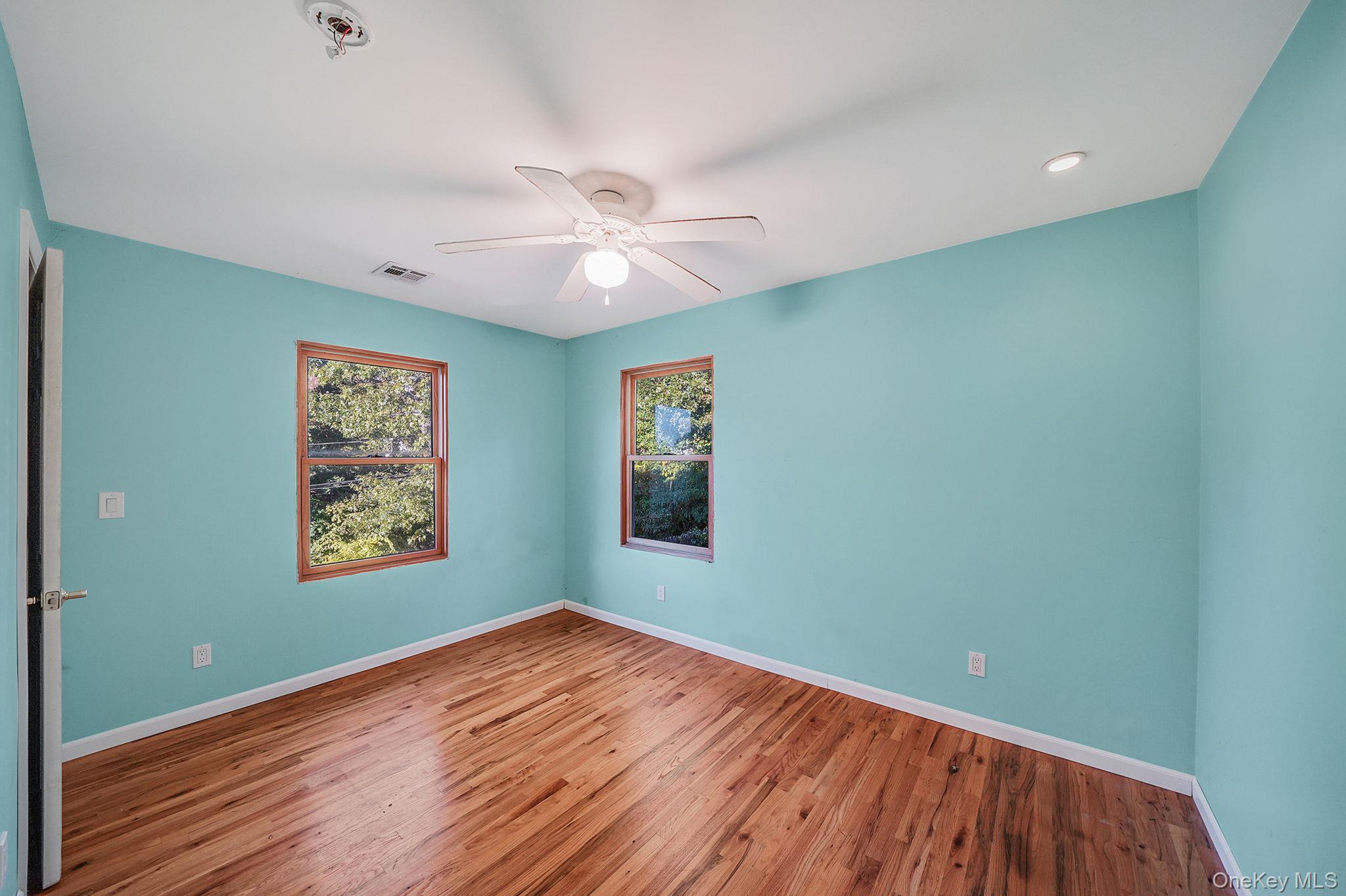 97 Locust Drive Rocky Point, NY 11778 - Photo 17 of 26 Empty room with wood finished floors, a ceiling fan, and recessed lighting