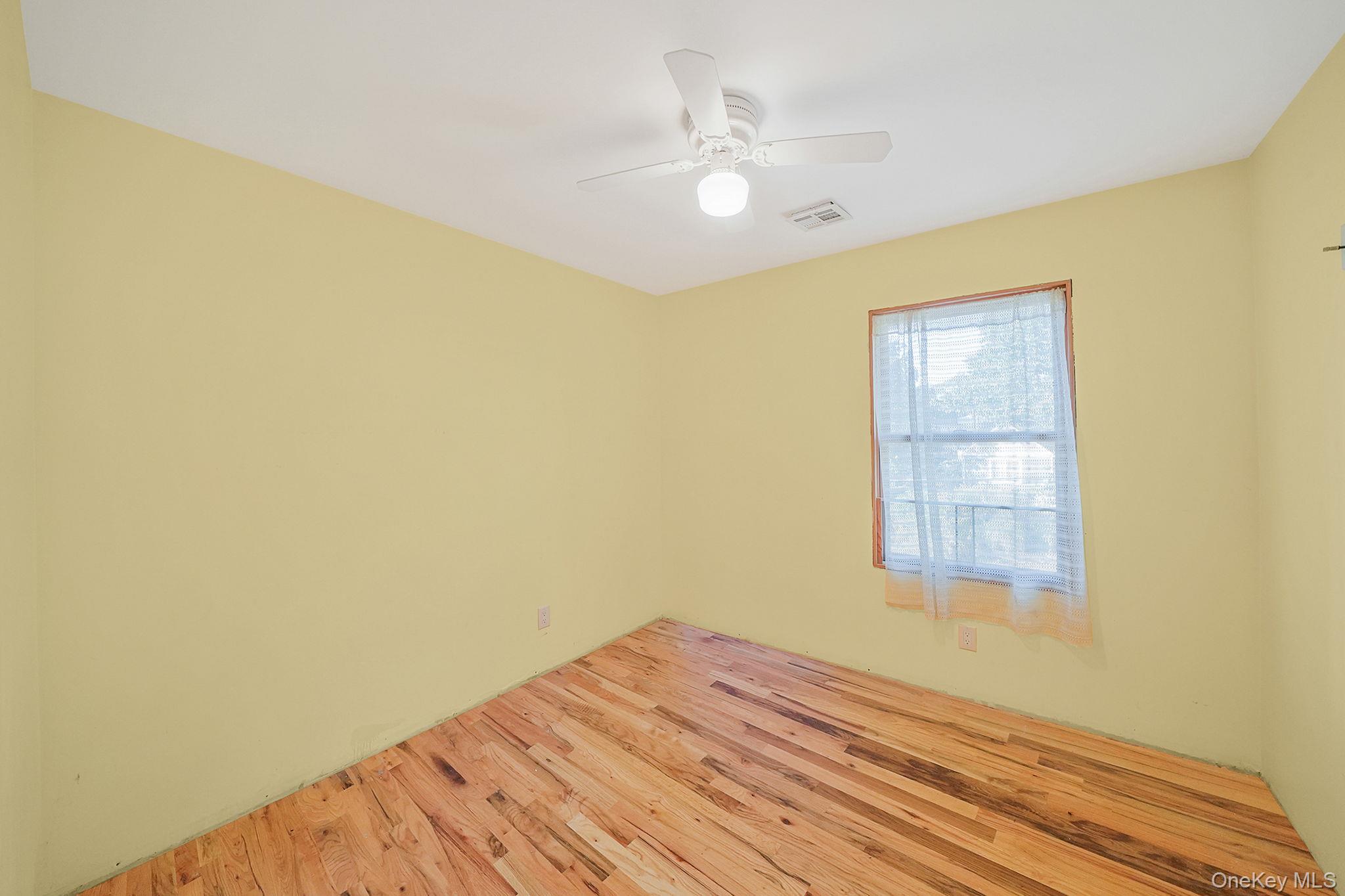 97 Locust Drive Rocky Point, NY 11778 - Photo 20 of 26 Spare room with wood finished floors and ceiling fan