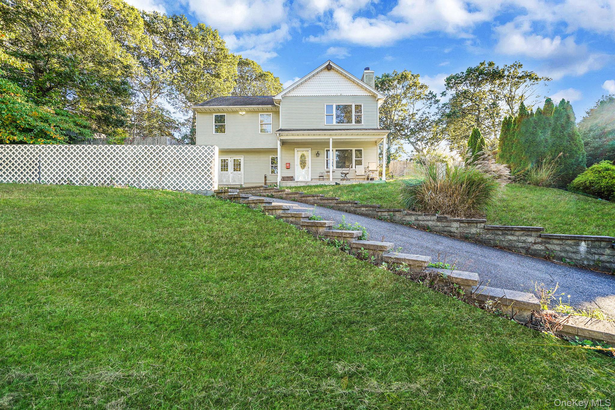 97 Locust Drive Rocky Point, NY 11778 - Photo 2 of 26 View of front of house with a chimney and a porch