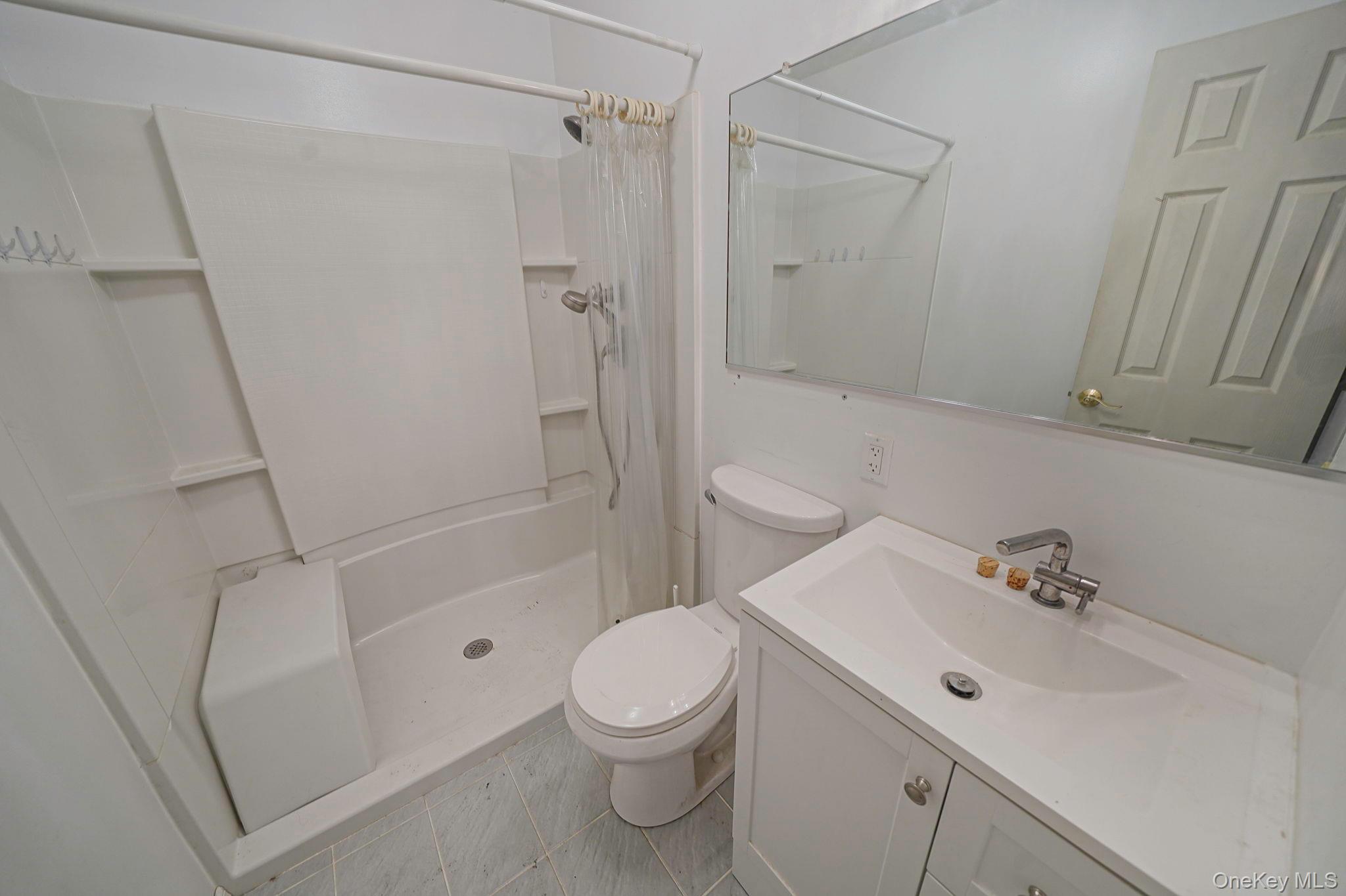 97 Locust Drive Rocky Point, NY 11778 - Photo 21 of 26 Bathroom featuring vanity and a shower with shower curtain
