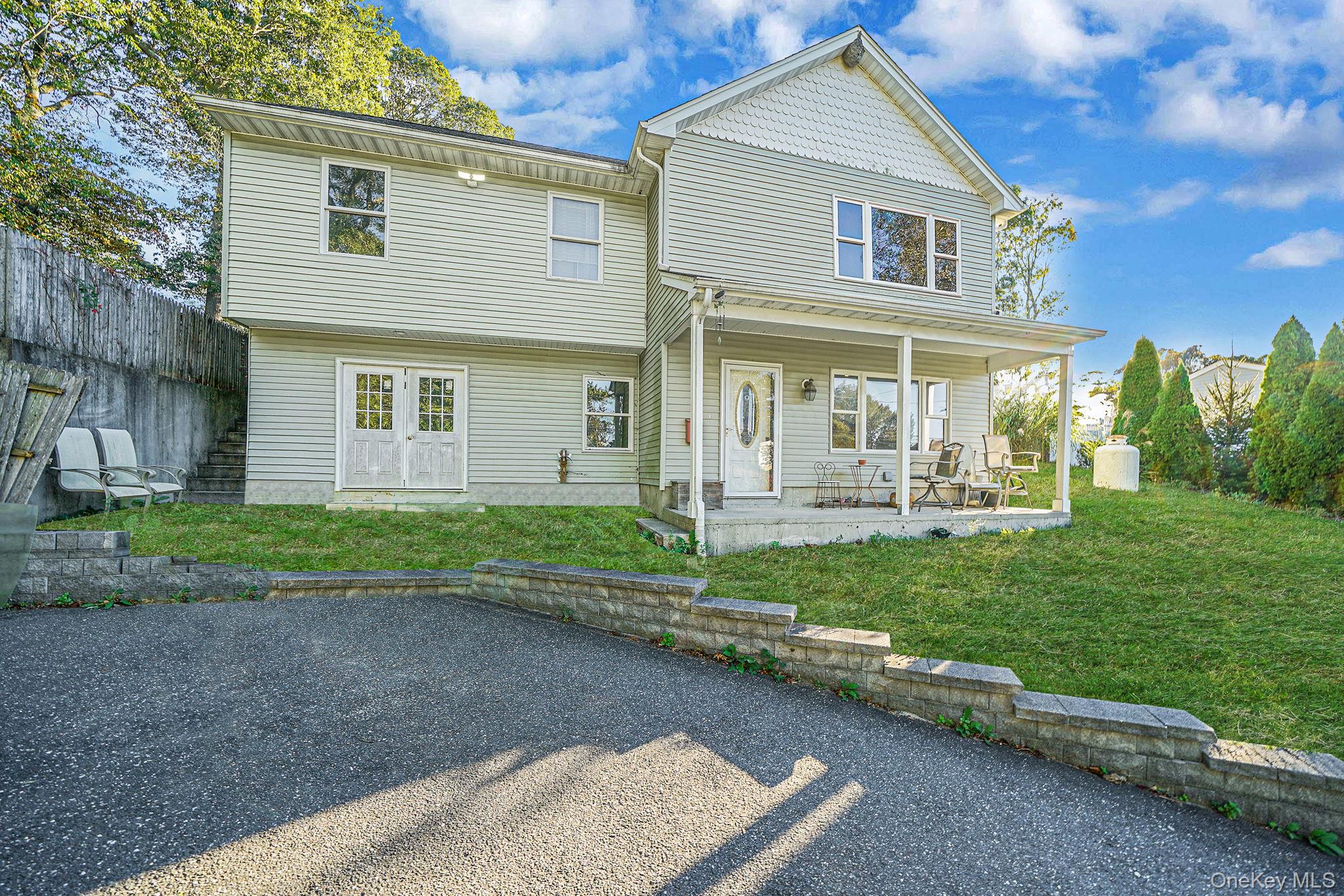 97 Locust Drive Rocky Point, NY 11778 - Photo 3 of 26 Rear view of property with a yard and a porch