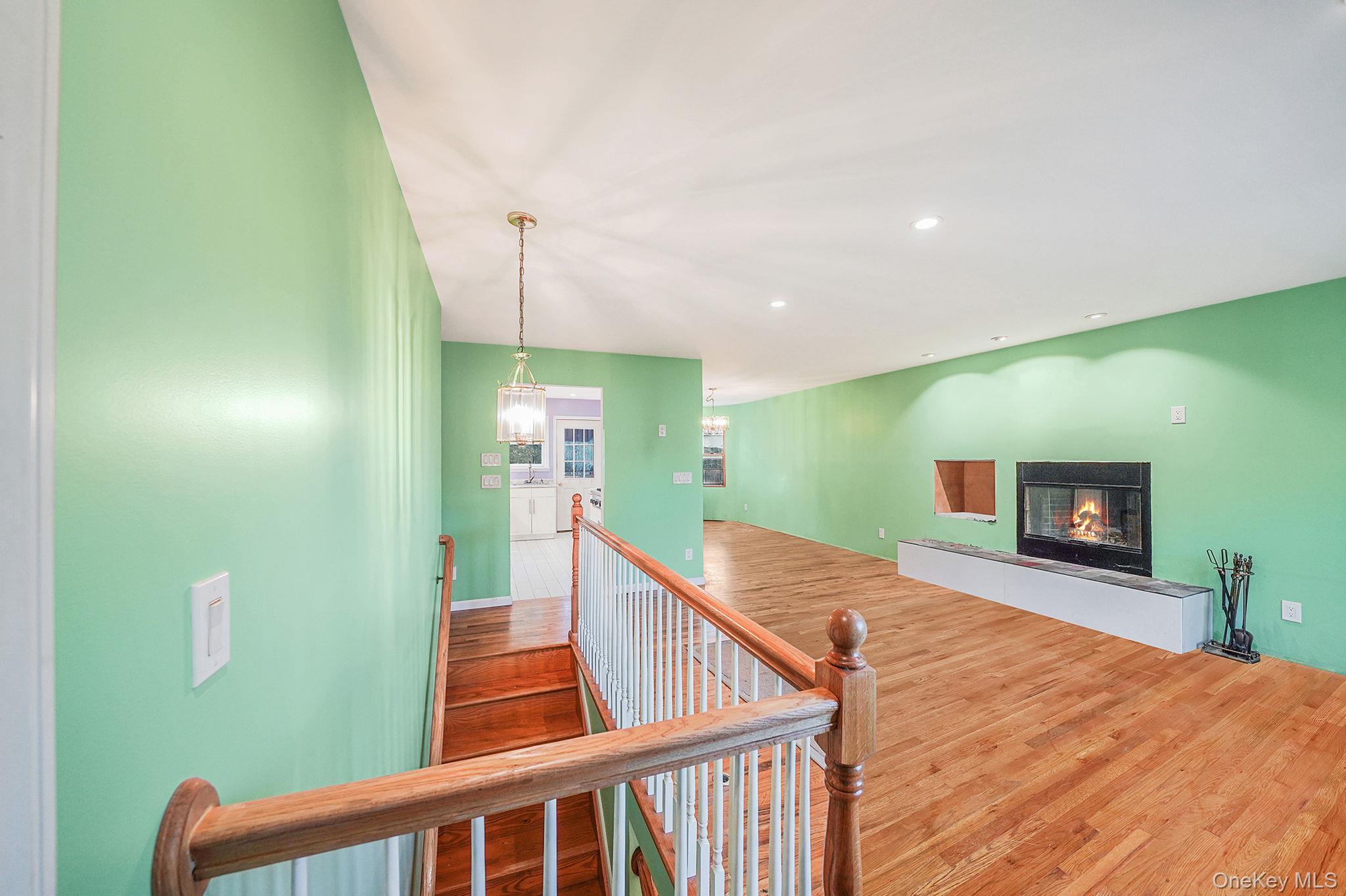 97 Locust Drive Rocky Point, NY 11778 - Photo 6 of 26 Hallway featuring wood finished floors, an upstairs landing, and recessed lighting