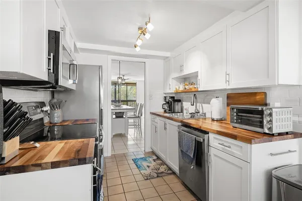 a kitchen with a sink cabinets and appliances