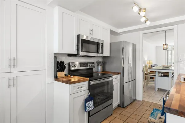 a kitchen with a refrigerator stove and microwave