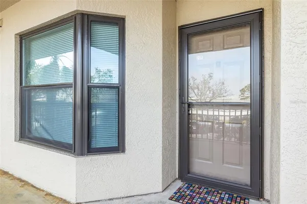 a bathroom with a glass shower door and a window