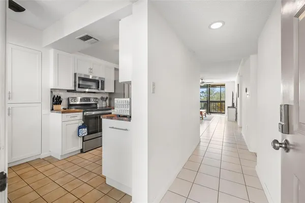 a kitchen with white cabinets a sink and stainless steel appliances