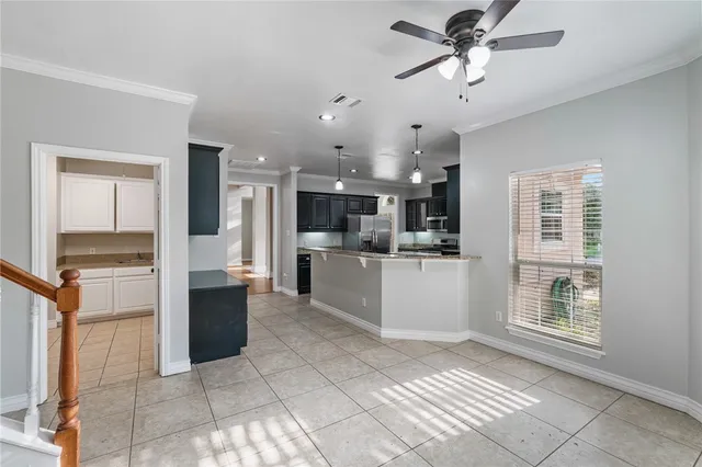 a view of kitchen with refrigerator and window