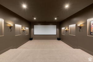 1141 East Lost Ridge Drive Washington, UT 84780 - Photo 90 of 108 Dedicated media room featuring a large projector screen, recessed ceiling lighting, and wall-mounted sconces