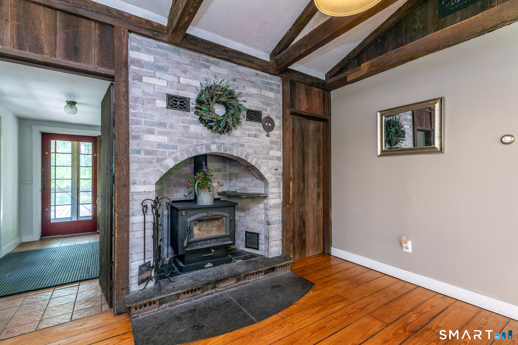 25 Bald Hill Road Kent, CT 06785 - Photo 7 of 38 Beyond the cozy stone alcove, functionality meets style. To the left sits a practical mudroom, while to the right, a massive walk-in pantry provides exceptional storage right off the main living area.