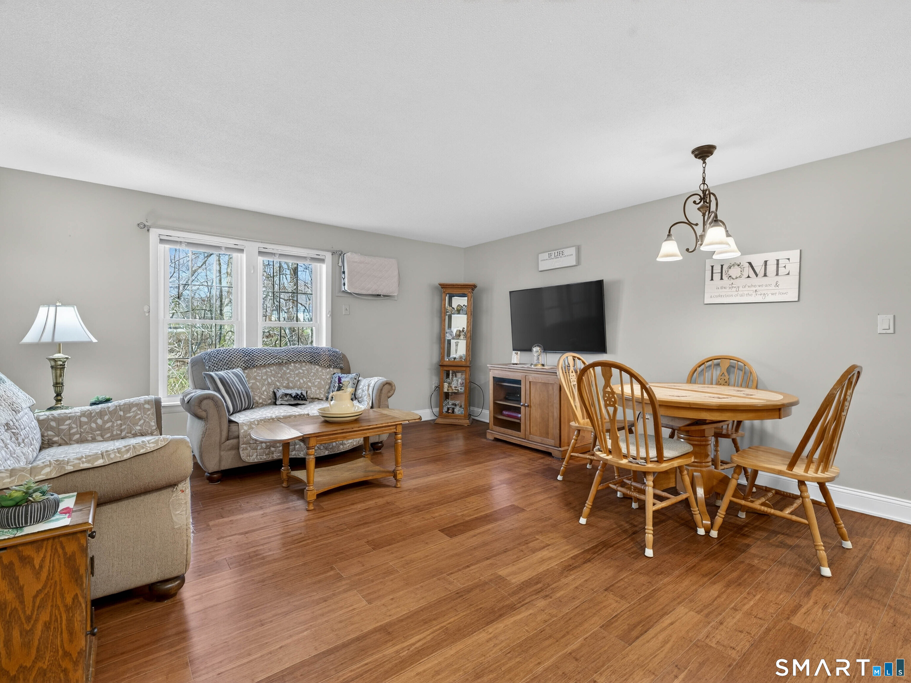 82 Sunset Street, Unit 68 Waterford, CT 06385 - Photo 1 of 20 a living room with furniture flat screen tv and wooden floor