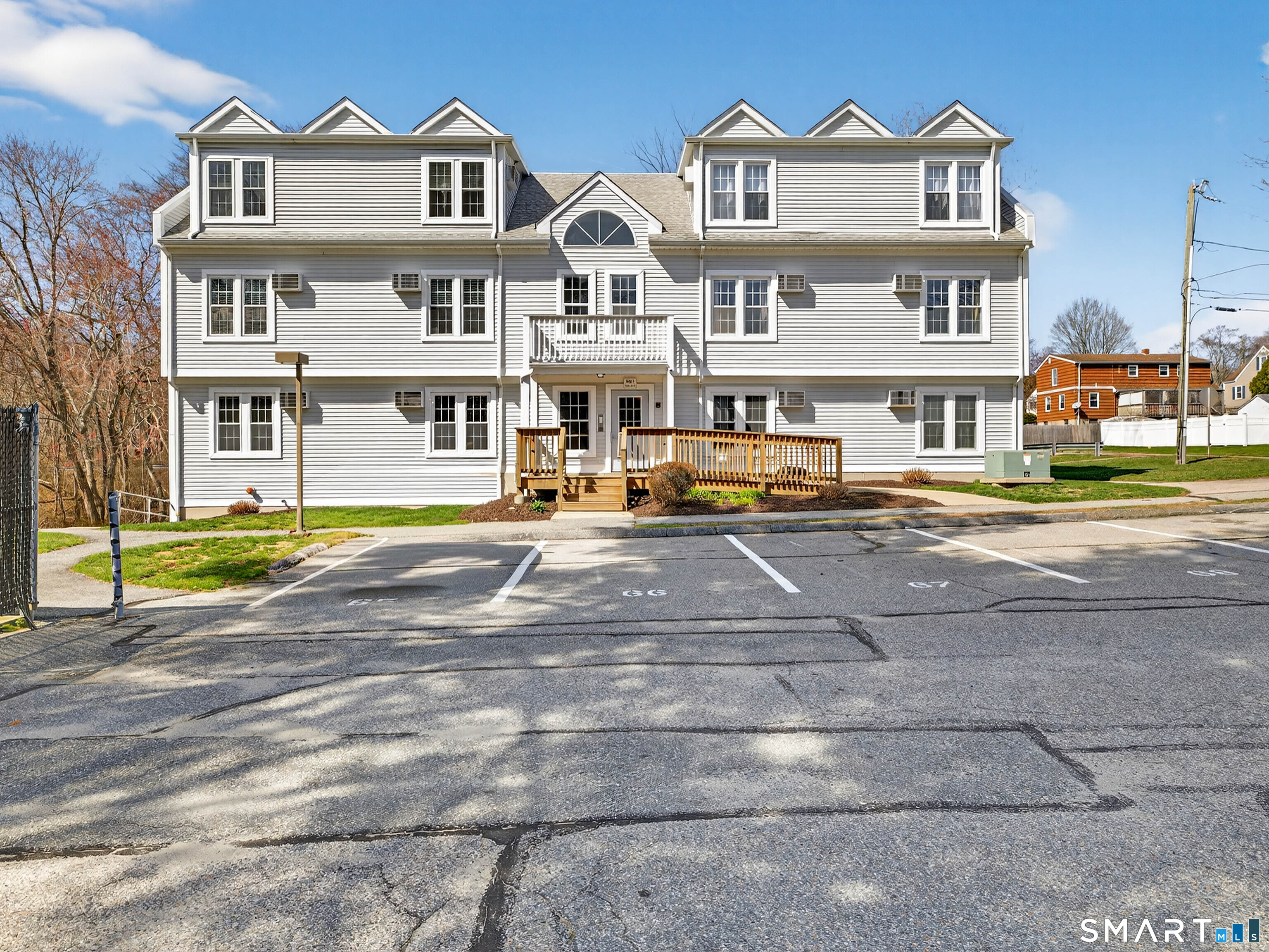 82 Sunset Street, Unit 68 Waterford, CT 06385 - Photo 16 of 20 a front view of a residential apartment building with a yard