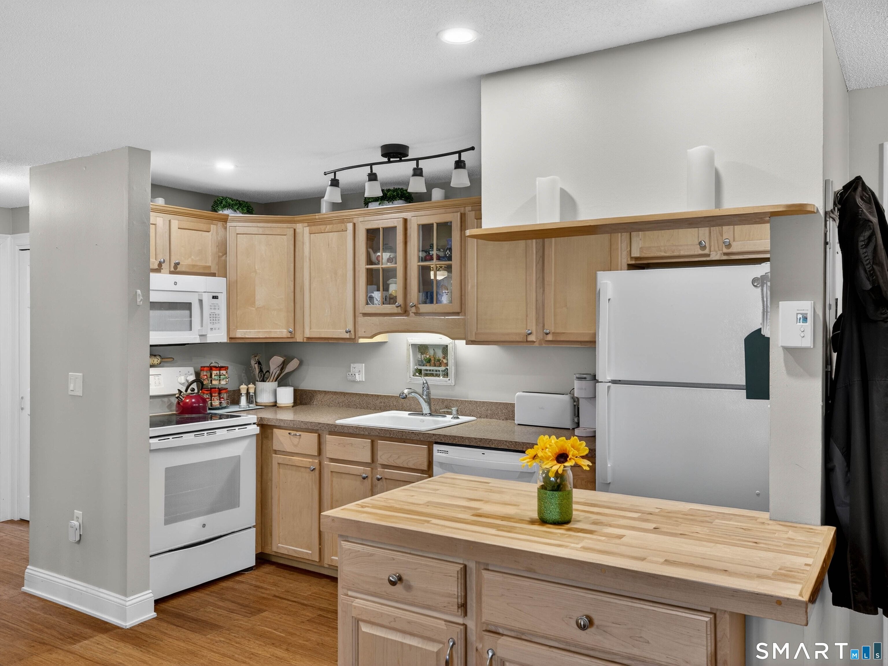 82 Sunset Street, Unit 68 Waterford, CT 06385 - Photo 4 of 20 a kitchen with a sink cabinets and wooden floor