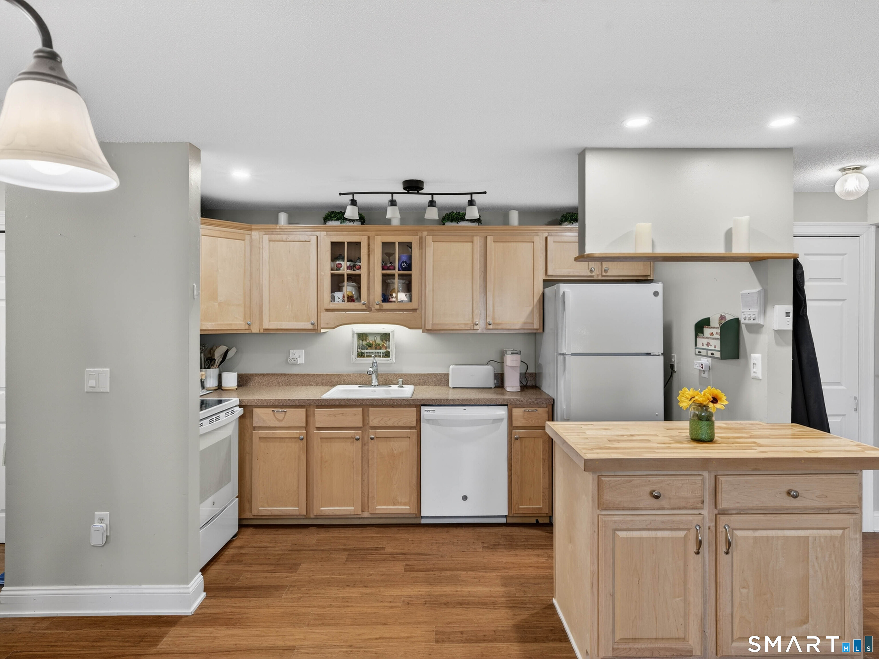 82 Sunset Street, Unit 68 Waterford, CT 06385 - Photo 9 of 20 a kitchen with a sink white cabinets and stainless steel appliances