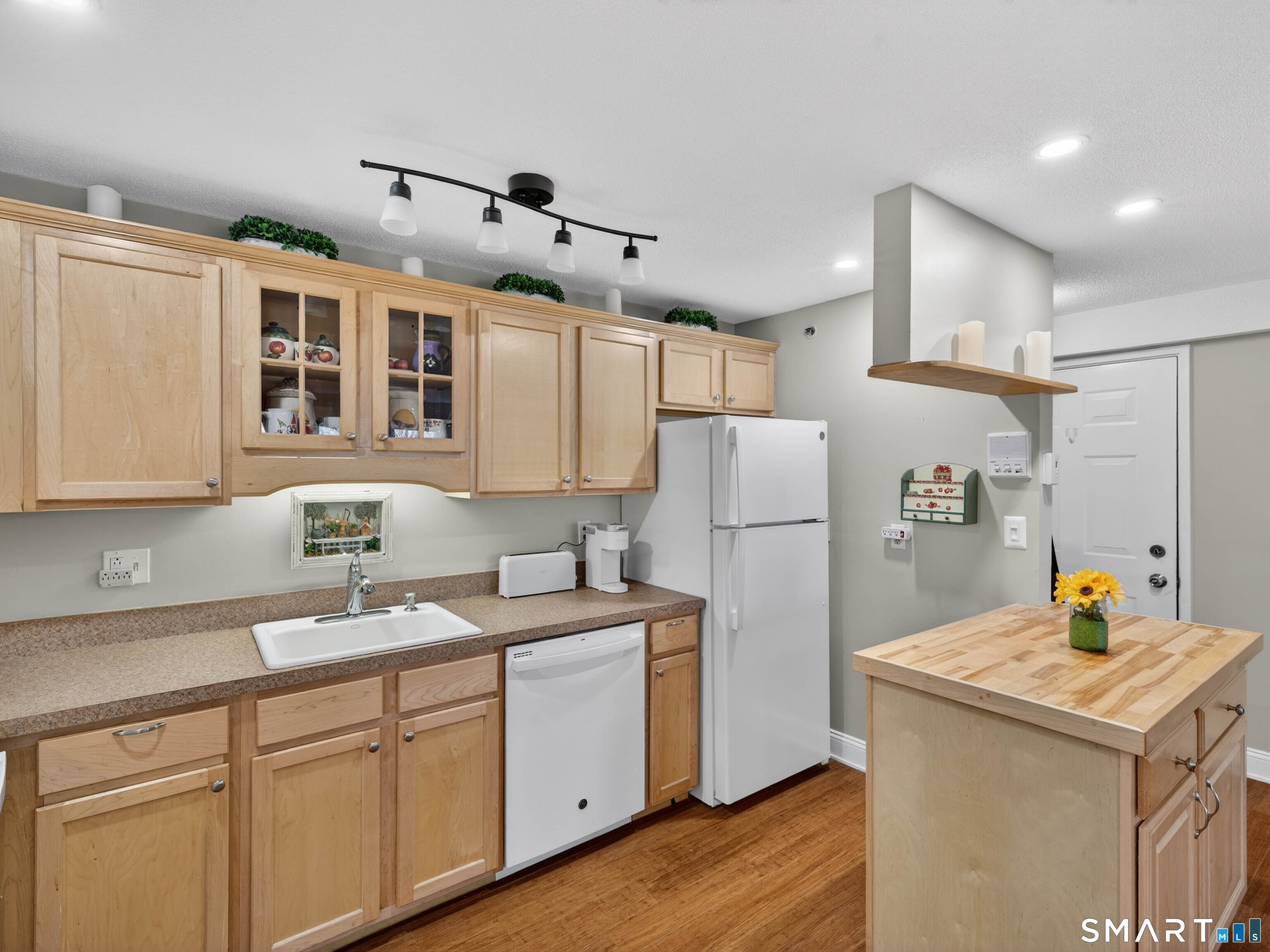 82 Sunset Street, Unit 68 Waterford, CT 06385 - Photo 10 of 20 a kitchen with refrigerator cabinets and wooden floor