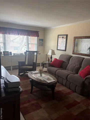 a living room with furniture a large window and a table