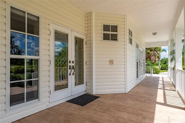 a large kitchen with granite countertop a sink and cabinets