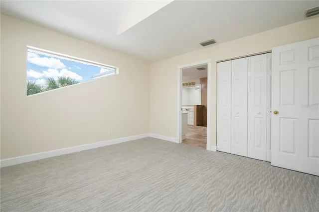 a view of a porch with furniture and floor to ceiling window