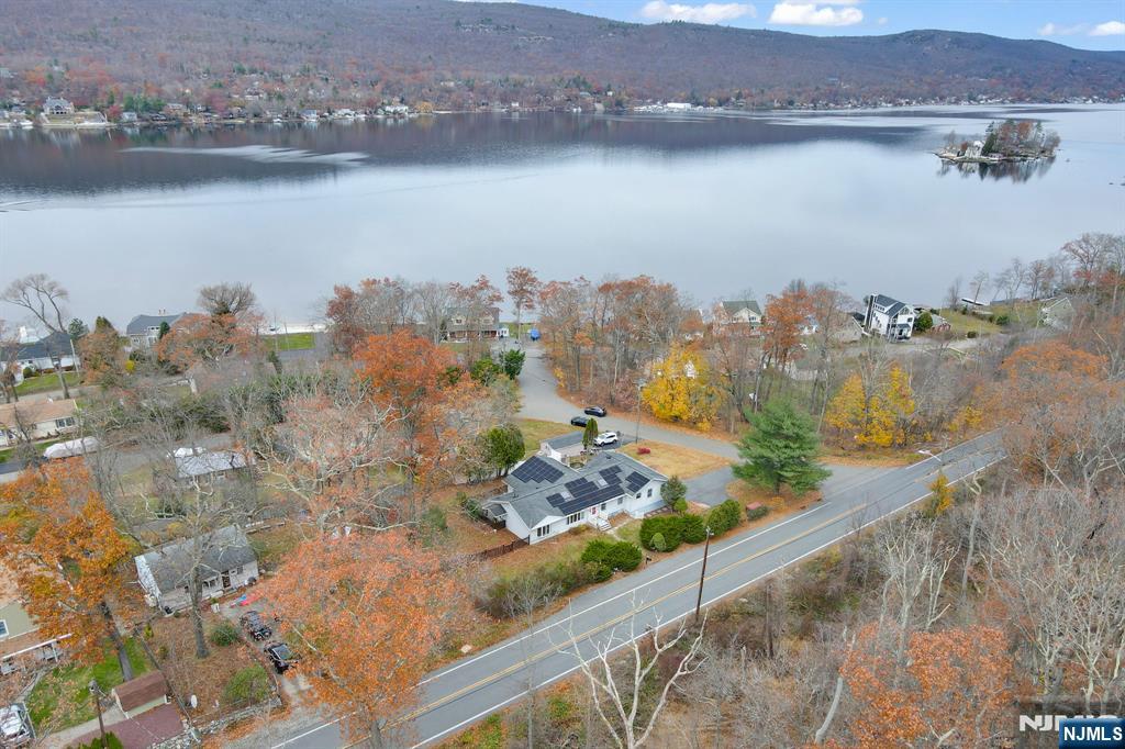 699 Shore Road West Milford, NJ 07421 - Photo 1 of 50 an aerial view of a house with a lake view