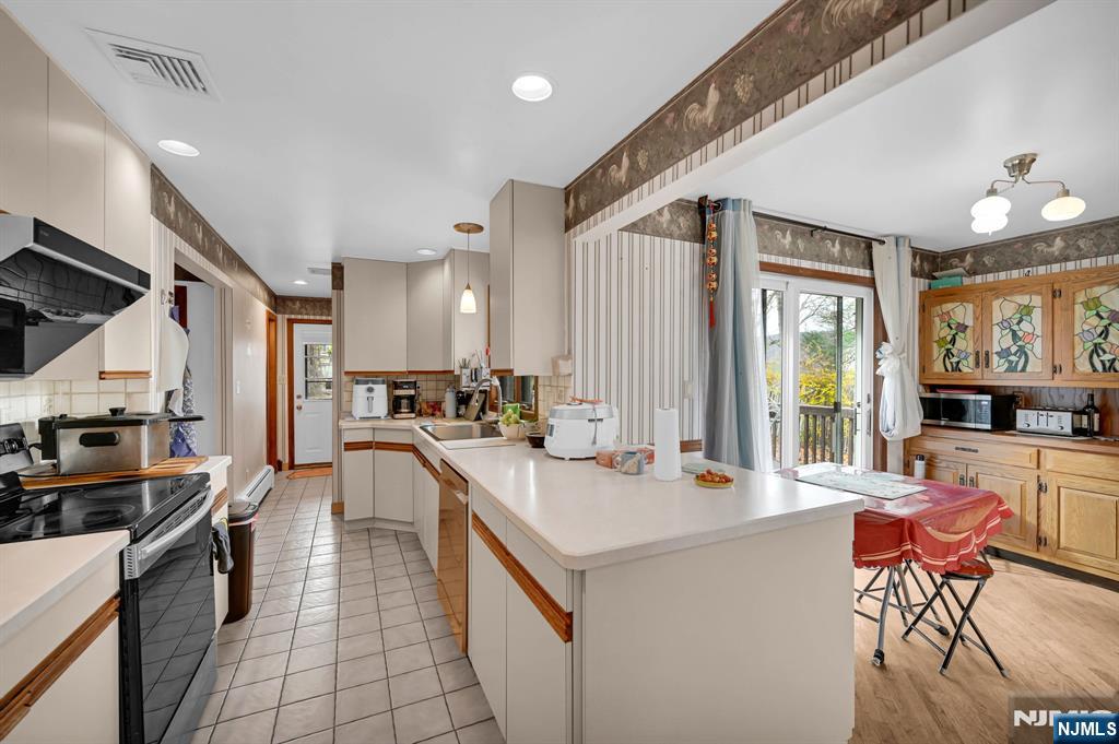 699 Shore Road West Milford, NJ 07421 - Photo 18 of 50 a large white kitchen with lots of counter top space