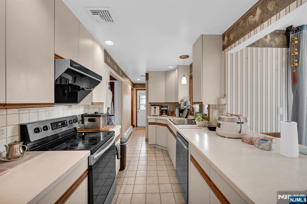 699 Shore Road West Milford, NJ 07421 - Photo 19 of 50 a kitchen with a sink a stove and cabinets
