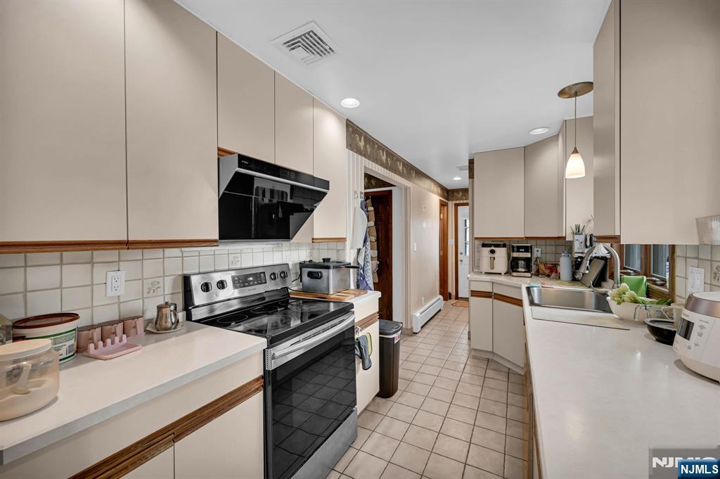 699 Shore Road West Milford, NJ 07421 - Photo 20 of 50 a kitchen with a sink a stove and cabinets
