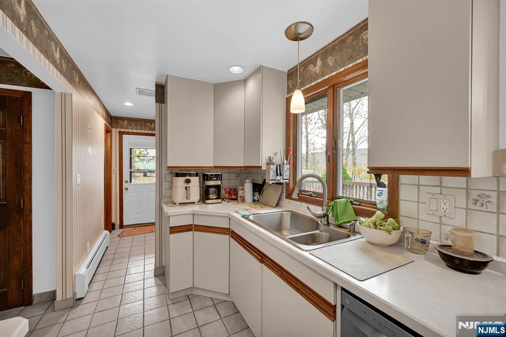 699 Shore Road West Milford, NJ 07421 - Photo 21 of 50 a kitchen with a sink appliances and cabinets