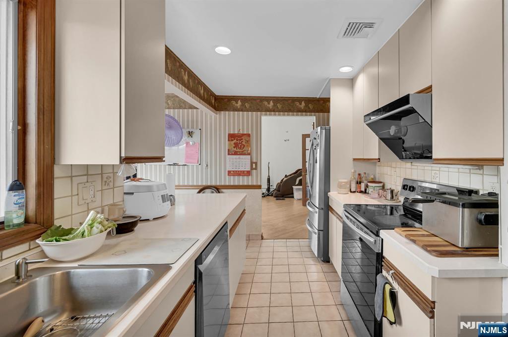 699 Shore Road West Milford, NJ 07421 - Photo 23 of 50 a kitchen with a sink stove and microwave