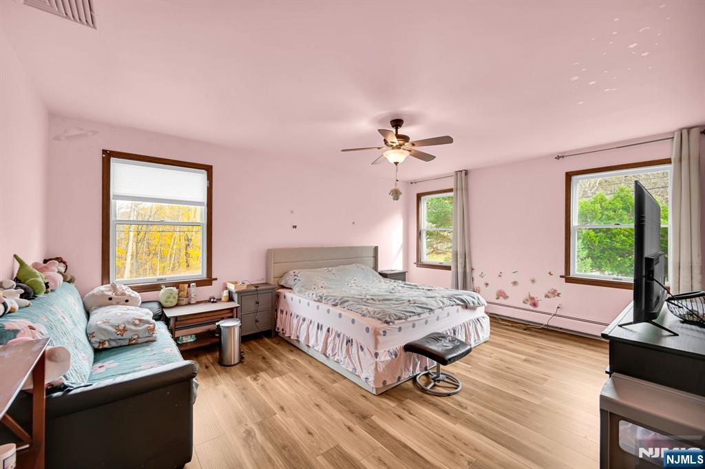 699 Shore Road West Milford, NJ 07421 - Photo 26 of 50 a bedroom with a bed and wooden floor