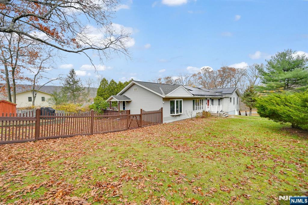 699 Shore Road West Milford, NJ 07421 - Photo 43 of 50 a view of a house with a wooden fence