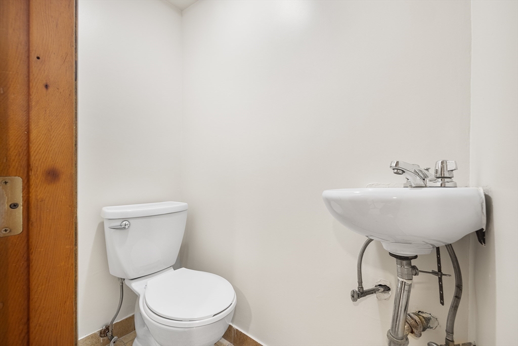 19 Johnson Avenue Winthrop, MA 02152 - Photo 18 of 42 a bathroom with a toilet sink and mirror