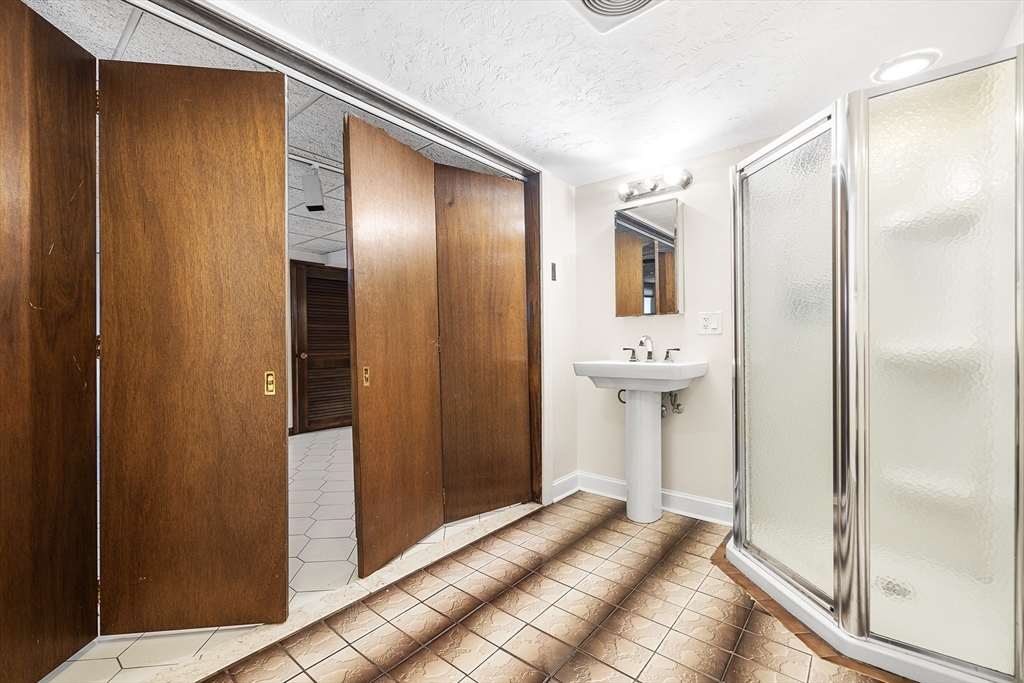 19 Johnson Avenue Winthrop, MA 02152 - Photo 20 of 42 a view of a bathroom with sink mirror and shower