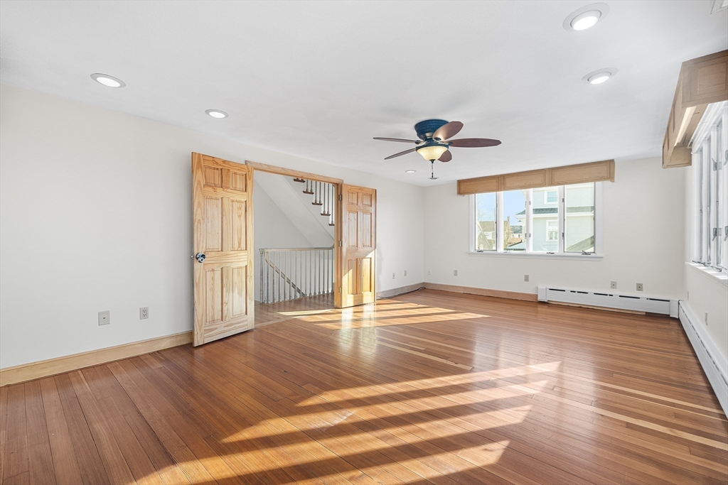 19 Johnson Avenue Winthrop, MA 02152 - Photo 22 of 42 a view of an empty room with a window and wooden floor
