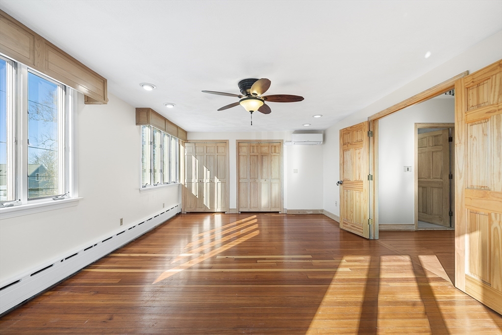 19 Johnson Avenue Winthrop, MA 02152 - Photo 23 of 42 a view of an empty room with a window and wooden floor