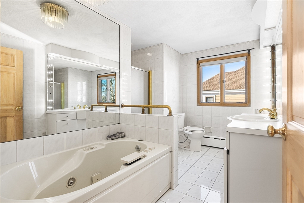 19 Johnson Avenue Winthrop, MA 02152 - Photo 24 of 42 a bathroom with a tub a sink and a window