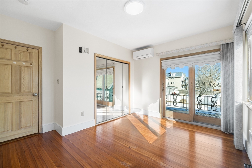 19 Johnson Avenue Winthrop, MA 02152 - Photo 26 of 42 an empty room with wooden floor and windows