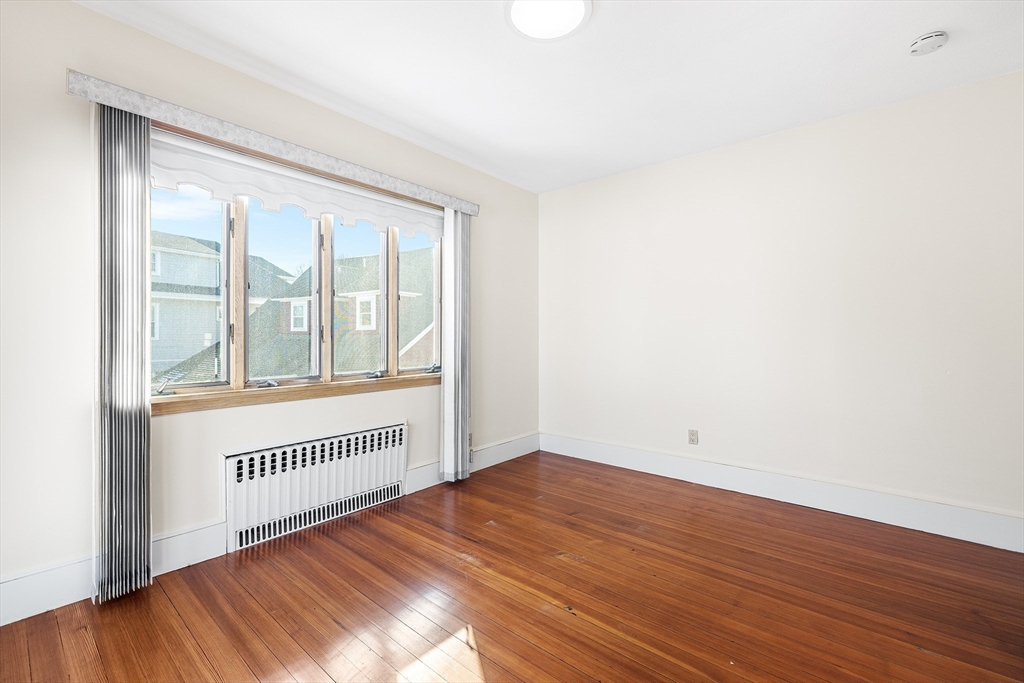 19 Johnson Avenue Winthrop, MA 02152 - Photo 27 of 42 a view of an empty room with wooden floor and a window