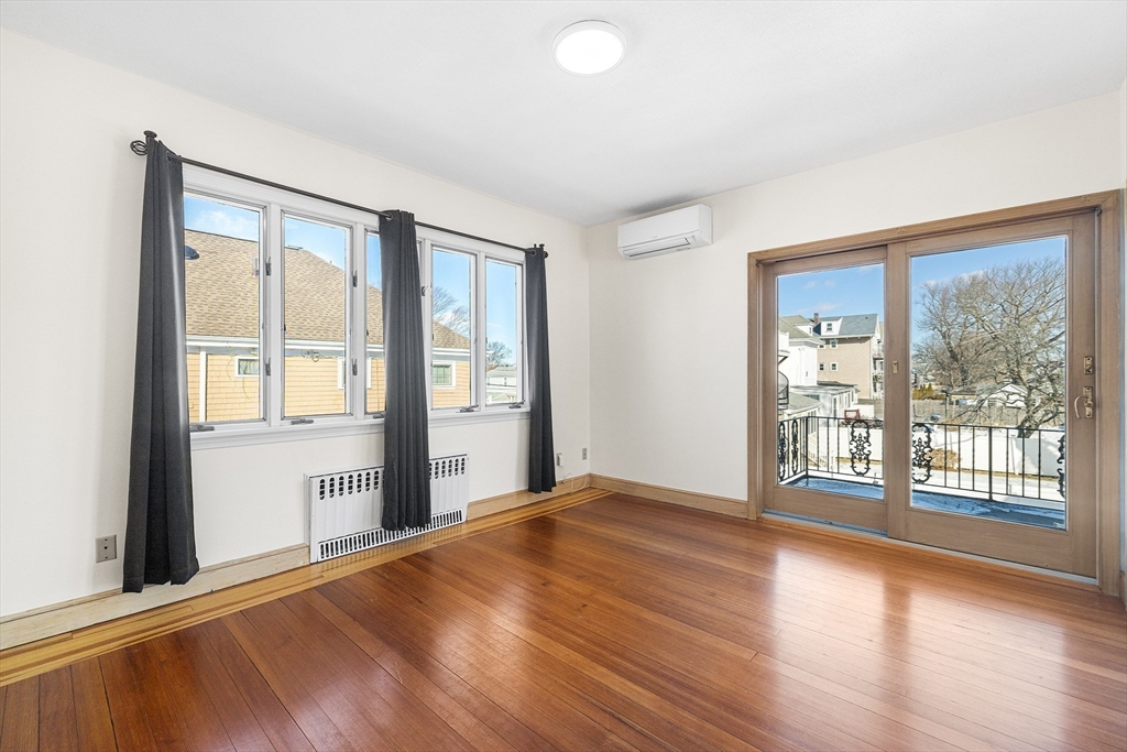 19 Johnson Avenue Winthrop, MA 02152 - Photo 29 of 42 a view of an empty room with wooden floor and a window