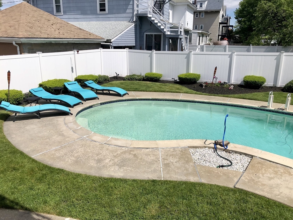 19 Johnson Avenue Winthrop, MA 02152 - Photo 37 of 42 a view of a swimming pool with a yard and plants