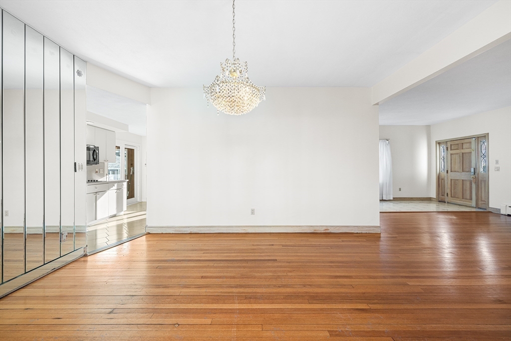 19 Johnson Avenue Winthrop, MA 02152 - Photo 4 of 42 a view of empty room with wooden floor and kitchen