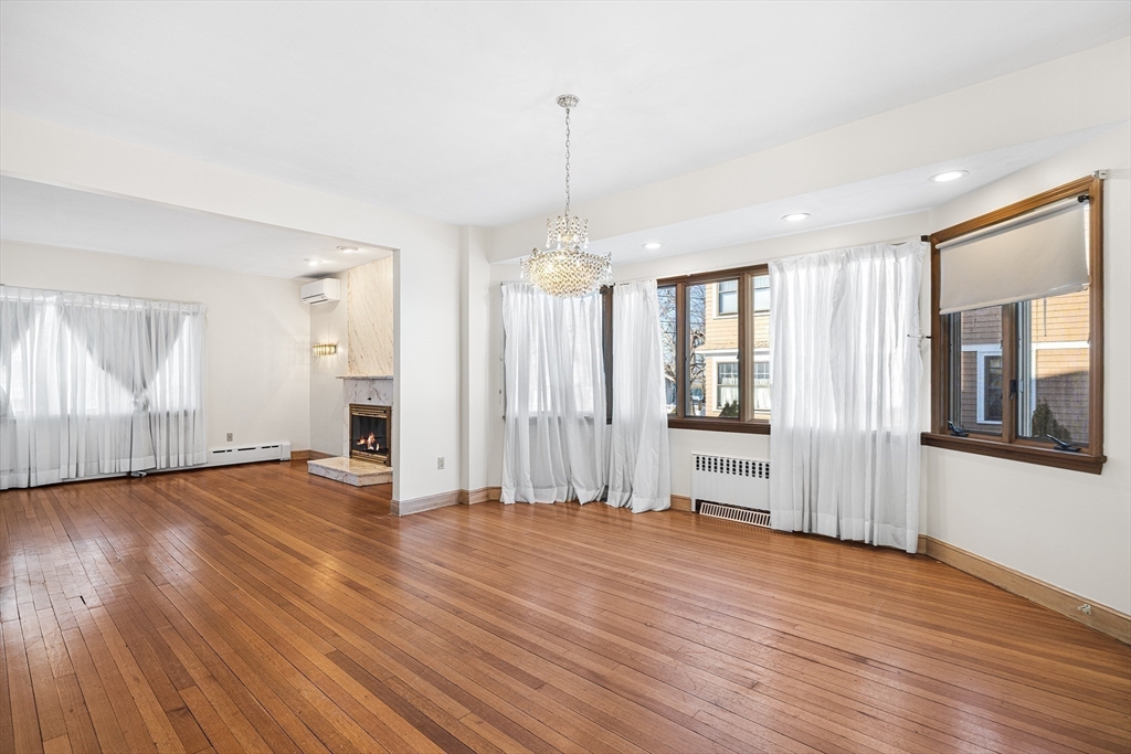 19 Johnson Avenue Winthrop, MA 02152 - Photo 6 of 42 an empty room with wooden floor and windows