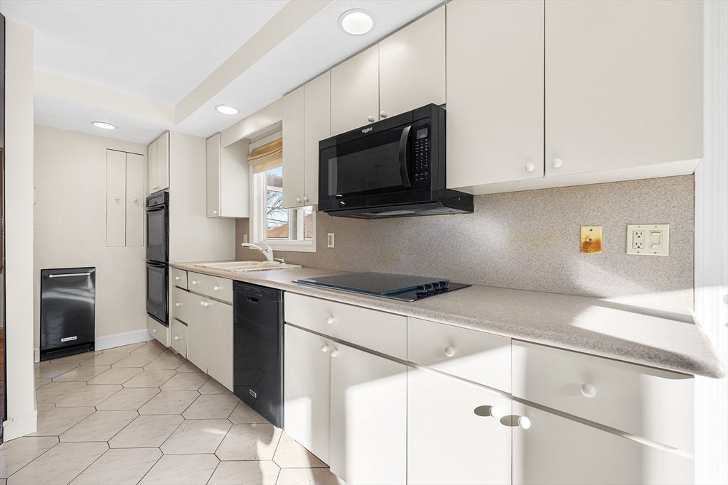 19 Johnson Avenue Winthrop, MA 02152 - Photo 8 of 42 a kitchen with stainless steel appliances granite countertop a refrigerator and a stove top oven