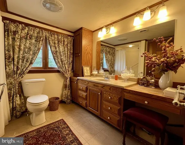 a bathroom with a toilet sink and mirror