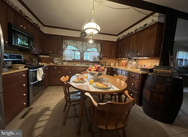 a view of a dining room with furniture and a chandelier