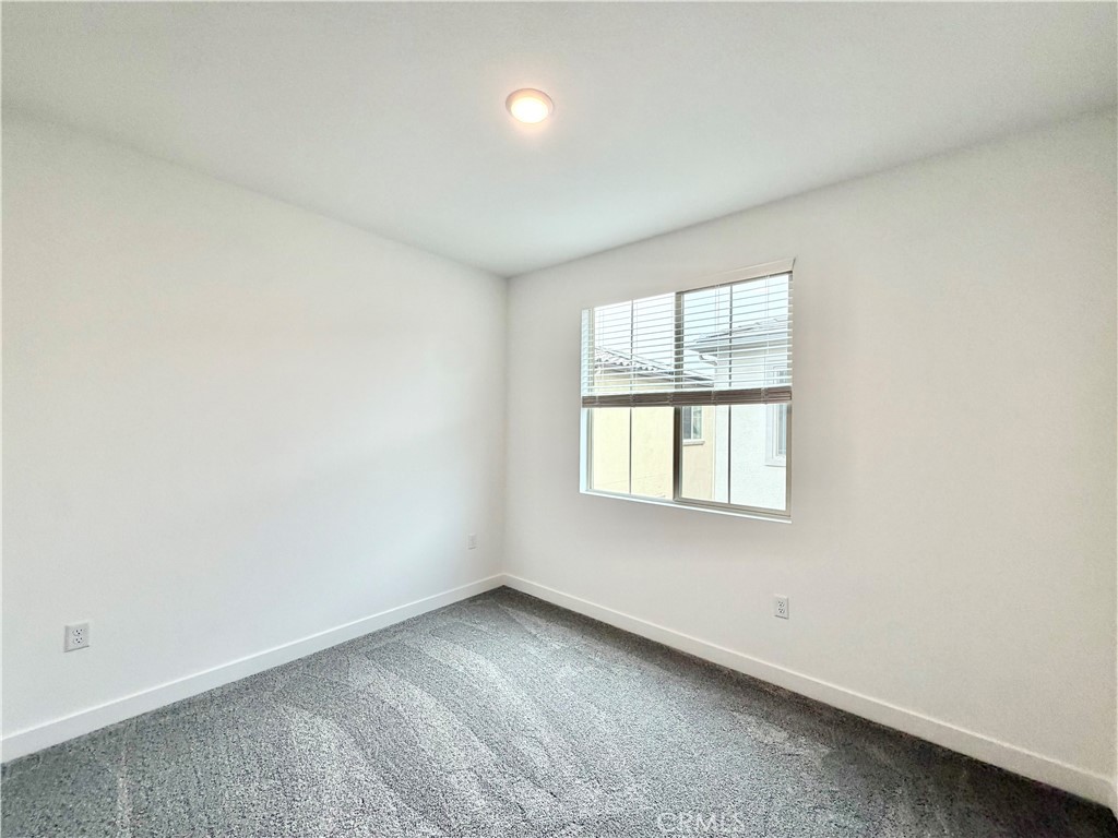 26893 Rubicon Road Menifee, CA 92586 - Photo 17 of 32 an empty room with a window
