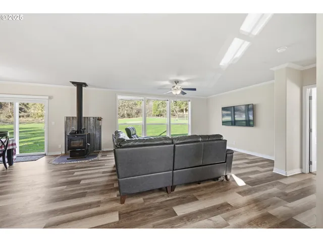 a living room with furniture and large windows