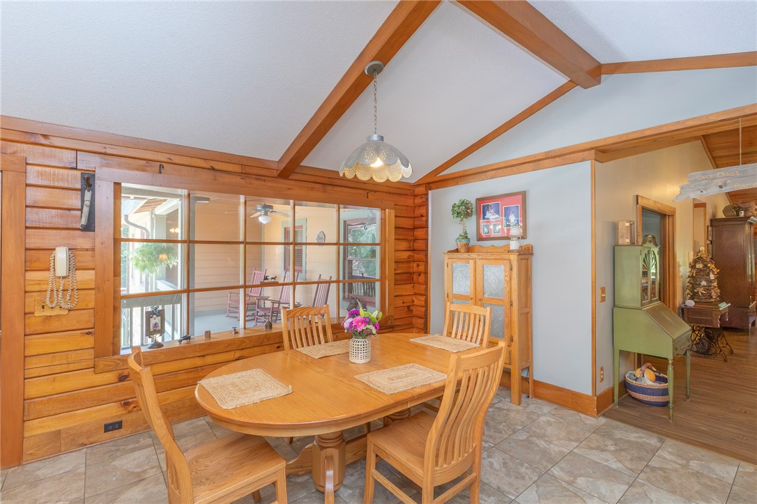 911 State Rd S-4-203 Belton, SC 29627 - Photo 16 of 49 Exposed wood beams add rustic charm to this bright dining area, perfect for intimate gatherings.