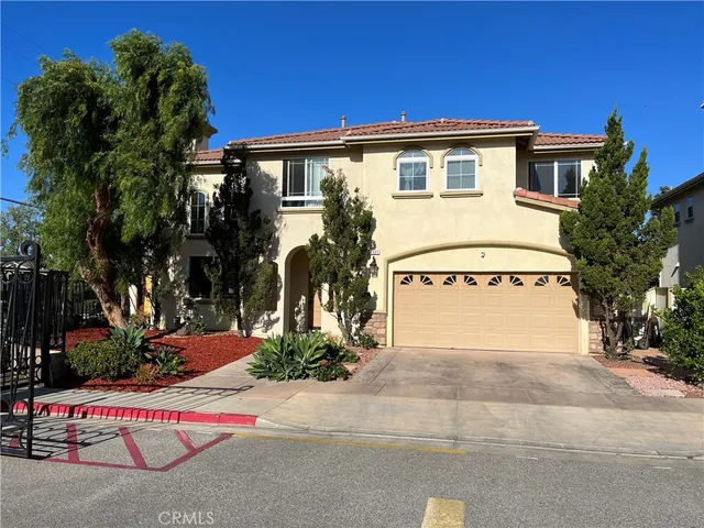 a white house with tree in front of it