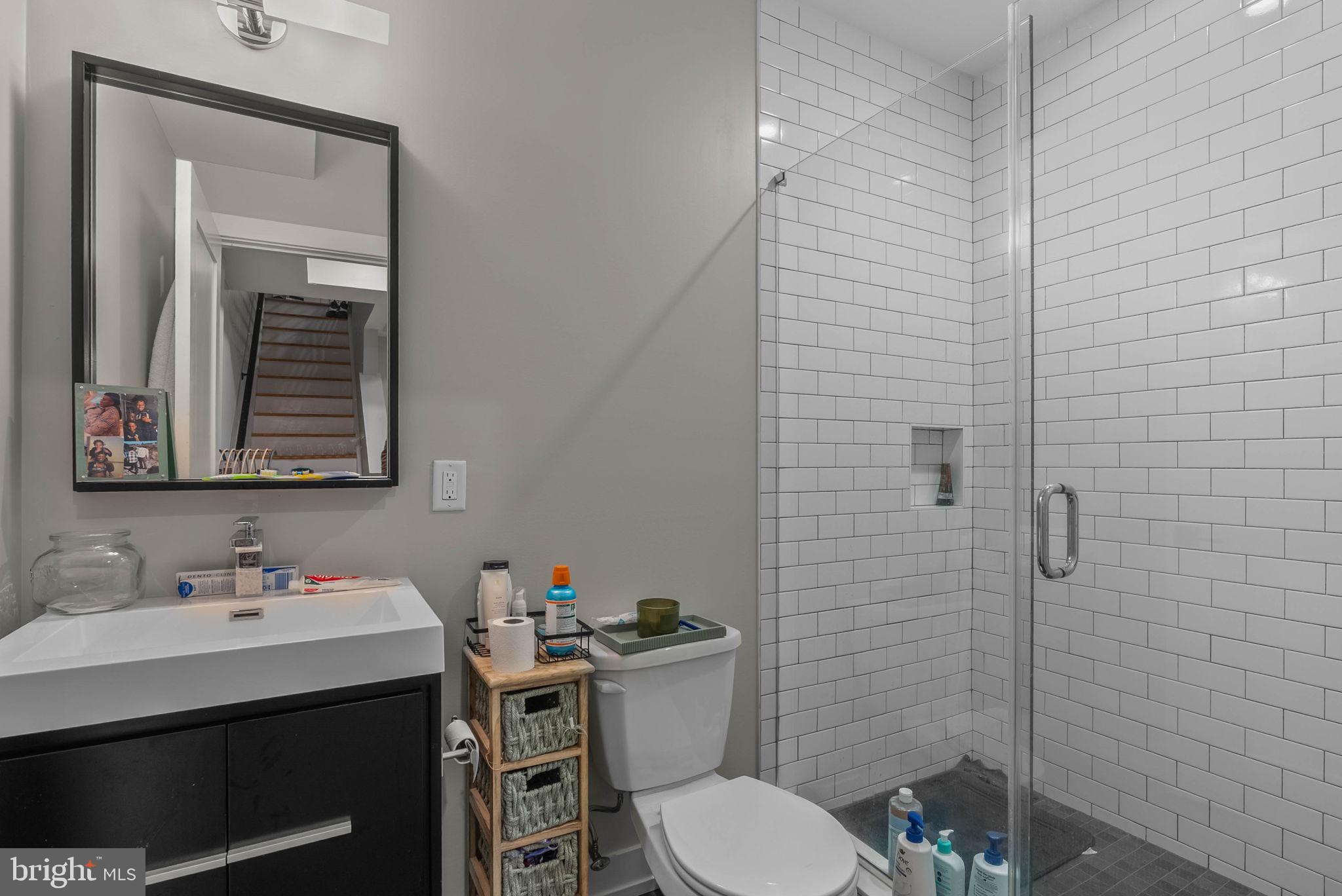 1517 North 27th Street Philadelphia, PA 19121 - Photo 15 of 31 a bathroom with a sink mirror toilet and shower