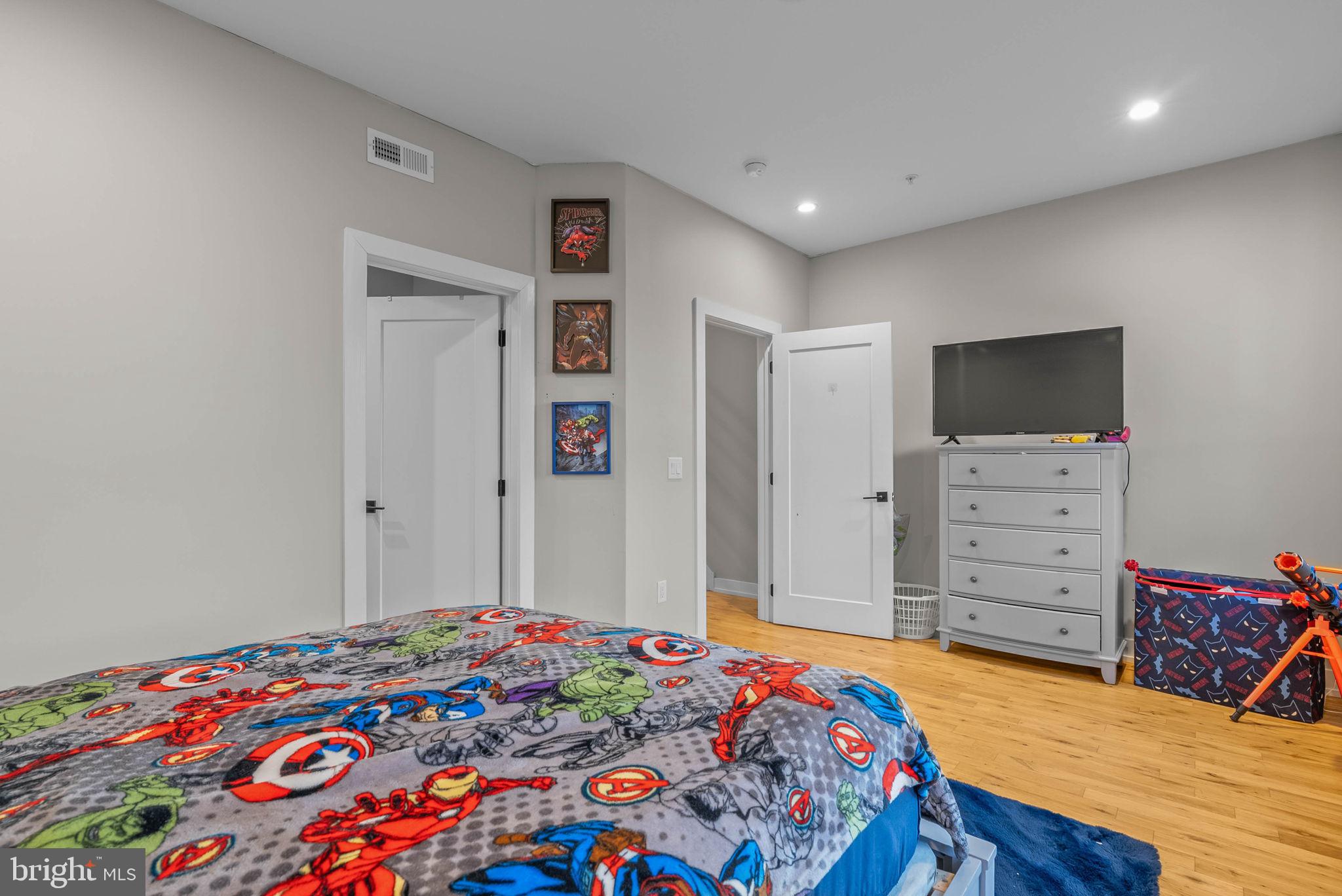 1517 North 27th Street Philadelphia, PA 19121 - Photo 23 of 31 a bedroom with a bed and a flat tv screen on dresser
