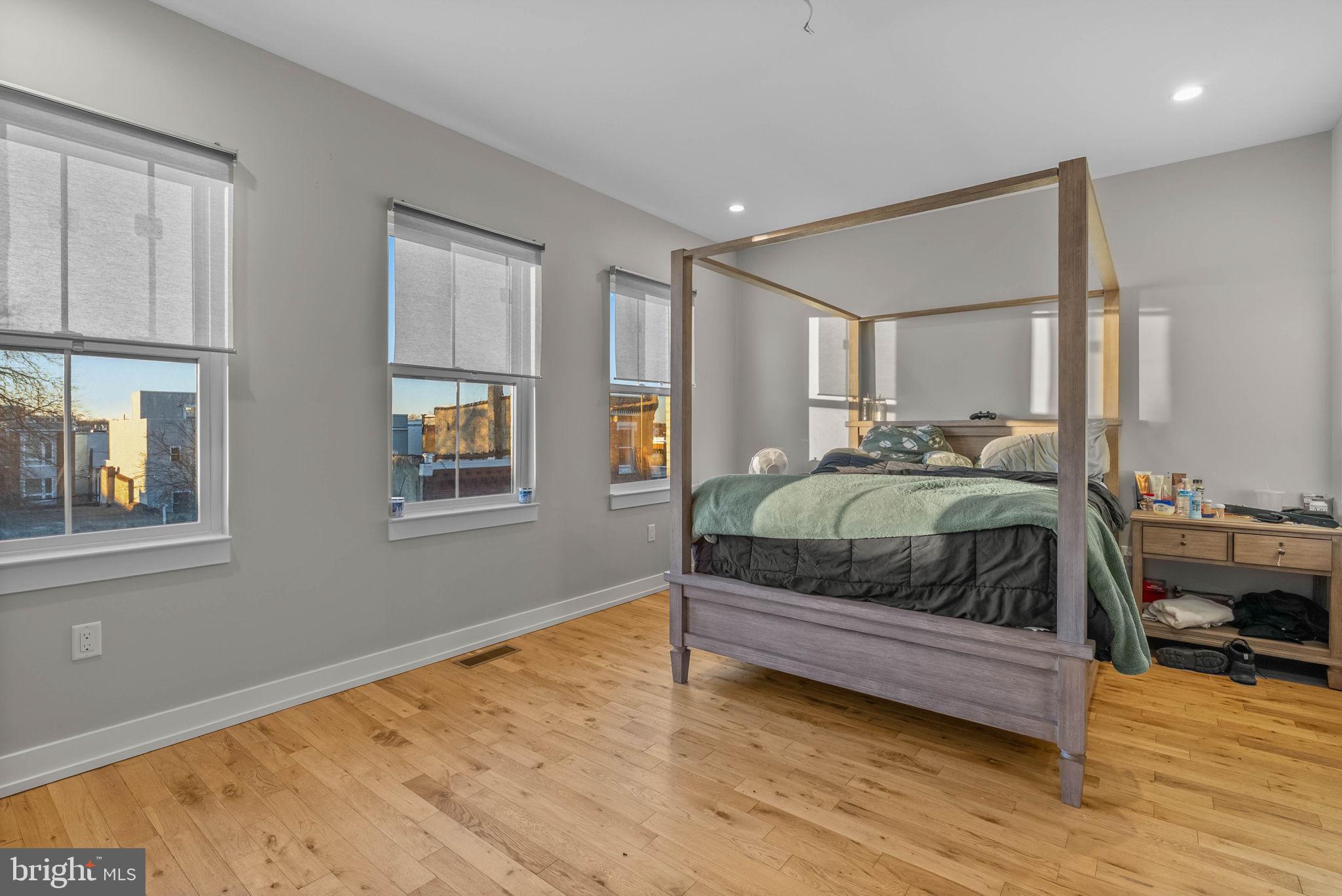 1517 North 27th Street Philadelphia, PA 19121 - Photo 28 of 31 a bedroom with a bed and wooden floor